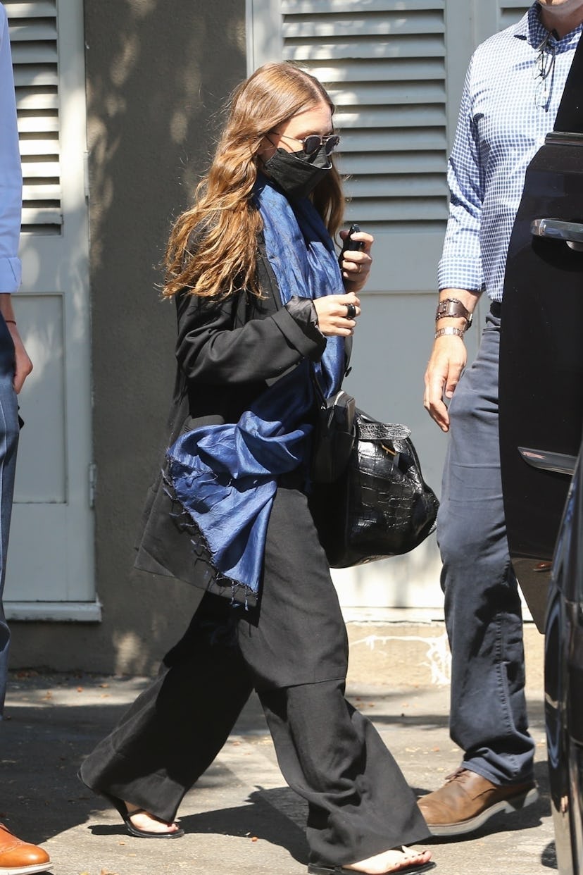 Ashley Olsen wearing a blue scarf in the summer