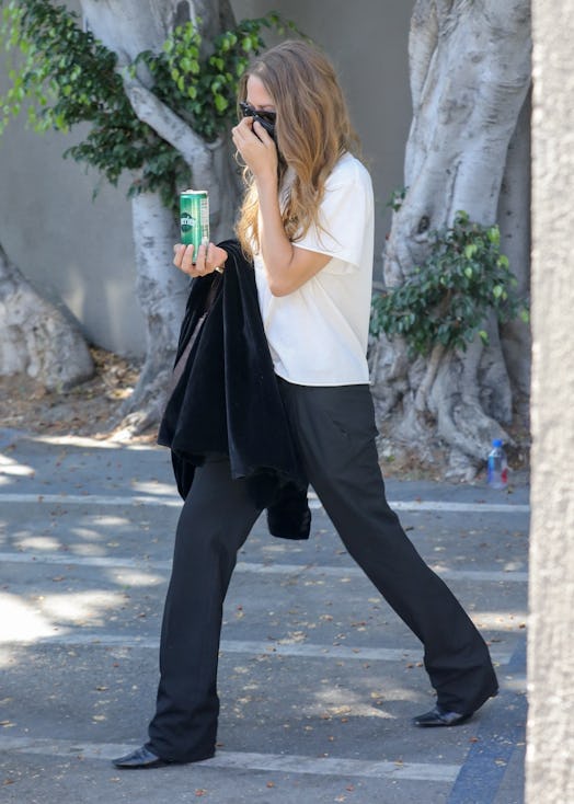 Mary-Kate Olsen wearing a white tee and black pants