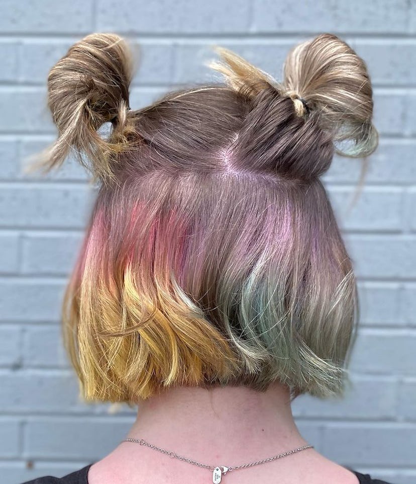 Girl wears rainbow colors on peek-a-boo blonde hair