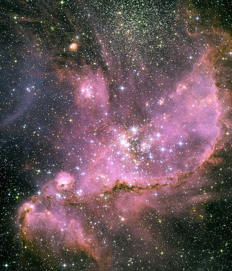 photo of stars amid purple gas clouds in space