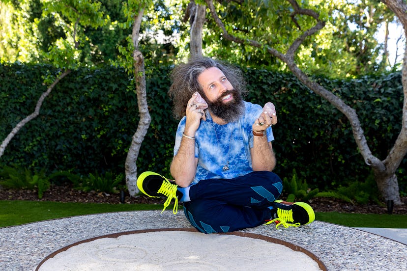 Elan Gale sitting with his legs crossed, looking up