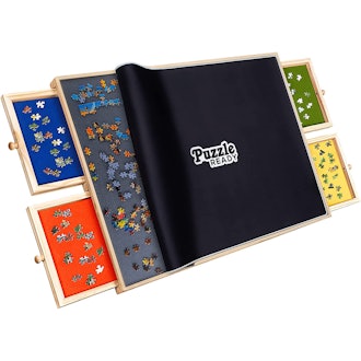 This puzzle mat has built-in drawers and a protective fabric cover.