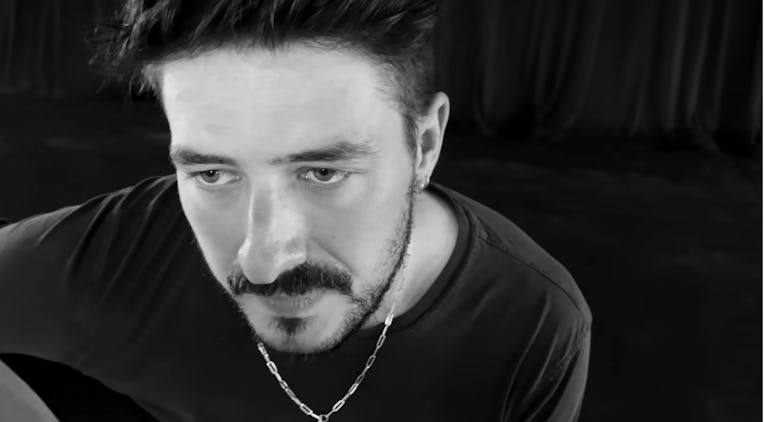 Marcus Mumford singing in his music video for "Cannibal"