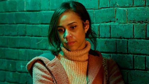 Zawe Ashton is pictured stood against a brick wall wearing a fluffy beige coat and fawn turtleneck i...
