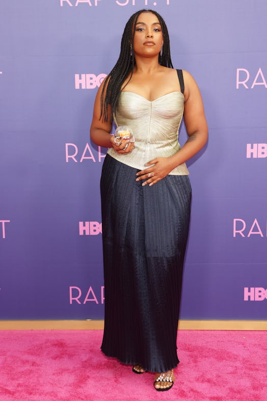 Aida Osman at the red-carpet premiere of Rap Sh!t at Hammer Museum in Los Angeles, in a gold top wit...