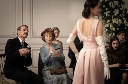 Marquis de Chassagne (Lambert Wilson) kindly accompanies Mrs. Harris (Manville) to the Dior showcase