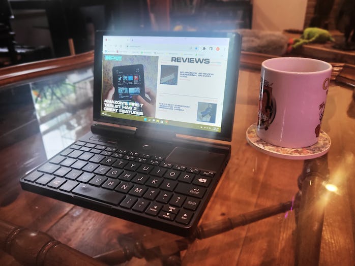 GPD Pocket 3 pictured on a glass coffee table beside a coffee mug for scale