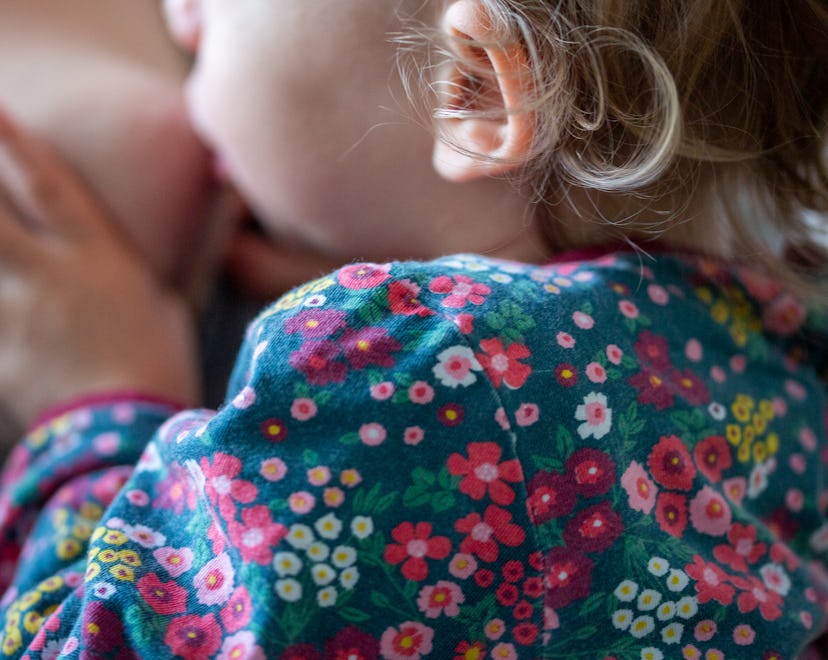 A mother breastfeeds her toddler. The new AAP guidelines recommend breastfeeding for at least two ye...