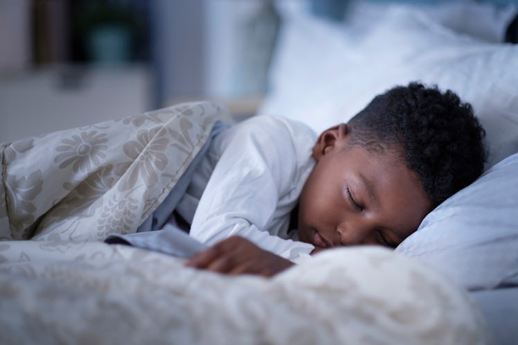 A boy sleeping in bed.