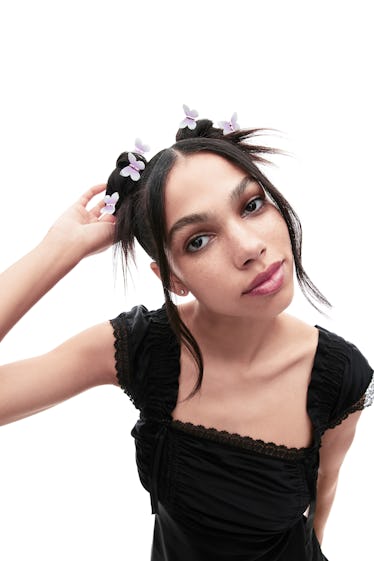 A person wearing Betsey Johnson x Jennifer Behr butterfly hair clips