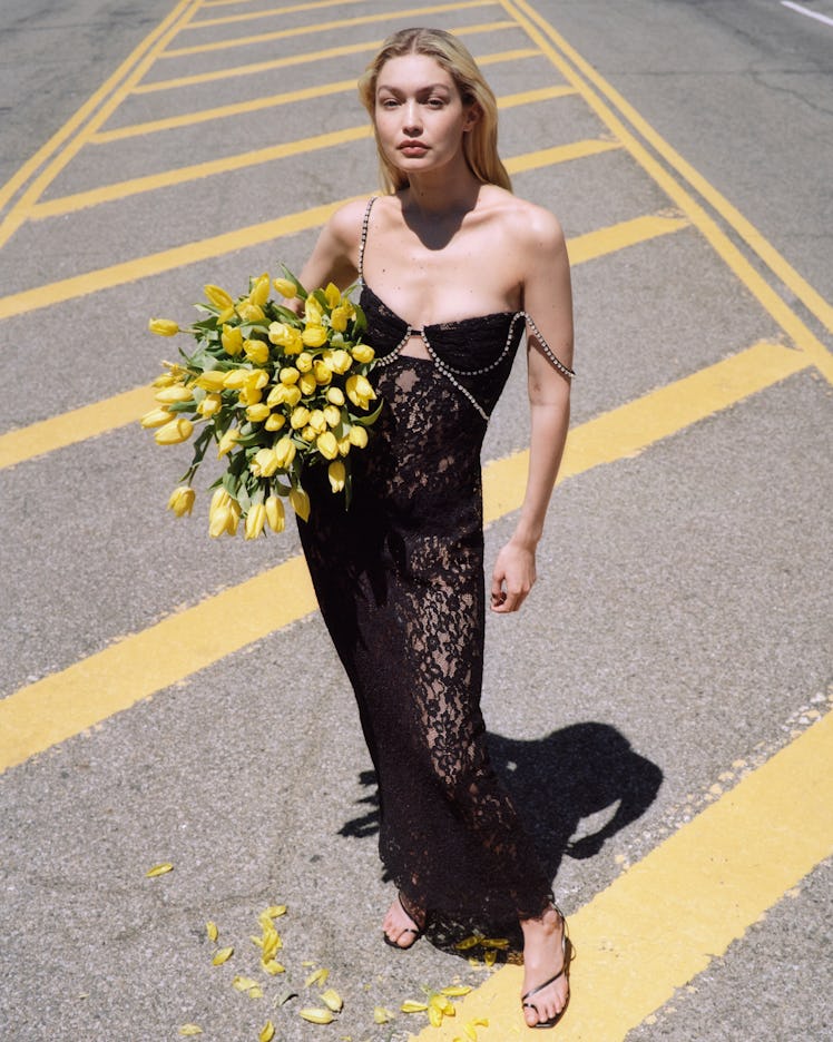Gigi Hadid carrying a bouquet of yellow flowers in her Self-Portrait campaign