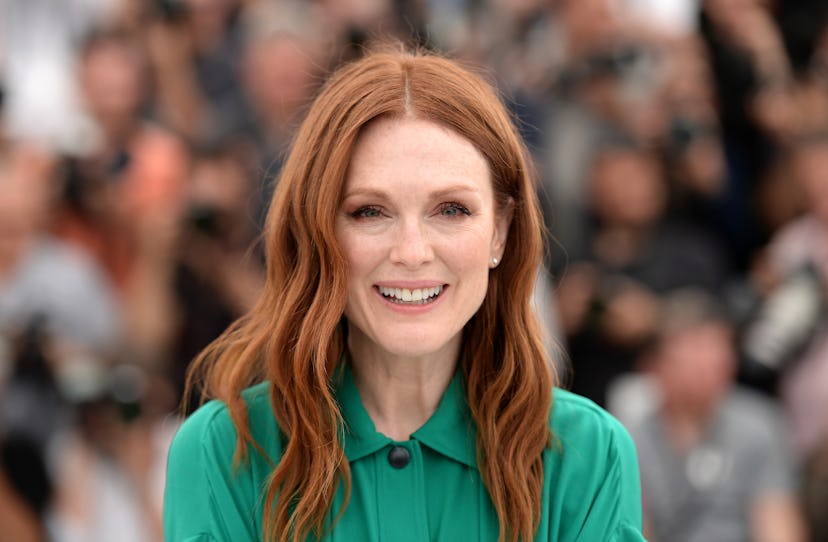 Julianne Moore smiling and wearing a green shirt