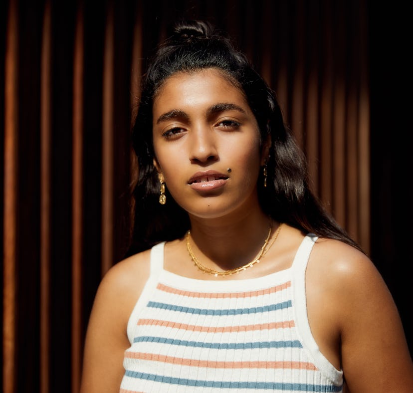 Young woman relaxing in the sun during the July 2022 new moon in Leo, which will affect her zodiac s...