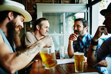 Group of middle aged men drinking beer in a restaurant