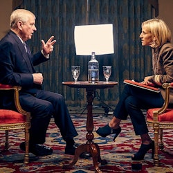 Prince Andrew sits in a red and gold chair wearing a navy suit opposite Emily Maitlis wearing a brow...