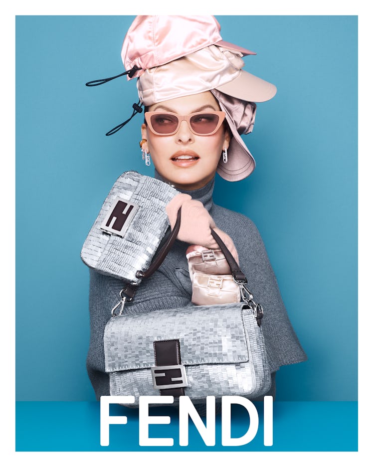 Linda Evangelista wearing a pile of baseball hats in her Fendi campaign