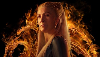 Eve Best's Princess Rhaenys Targaryen standing in front of fire in a promotional poster for House of...