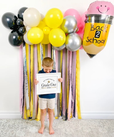 A pencil-themed photo backdrop is the perfect back-to-school decoration for a party.