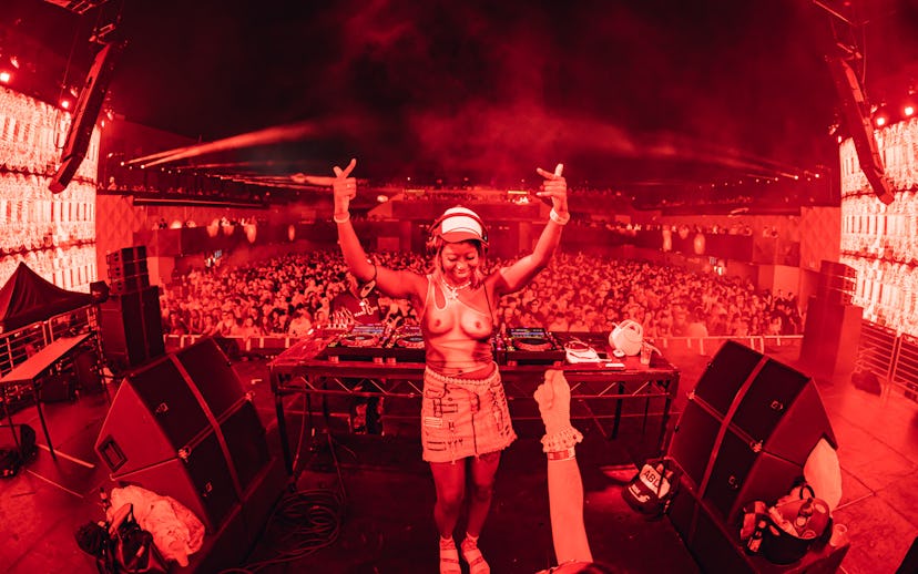 DJ Cry$cross flips off the camera while onstage at Boiler Room.