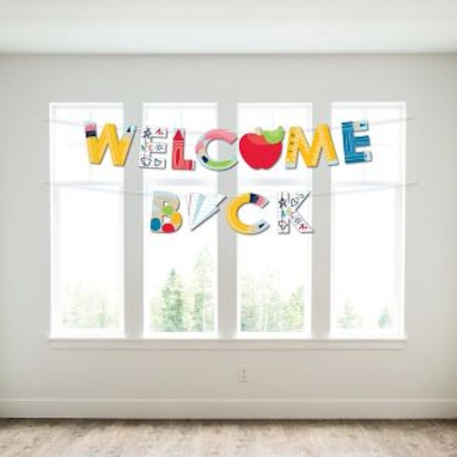 A big welcome back banner with apples and paper airplanes screams back to school.