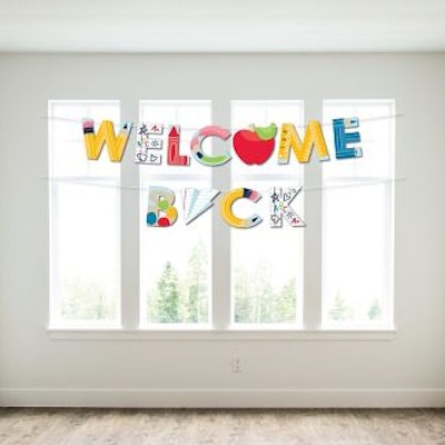 A big welcome back banner with apples and paper airplanes screams back to school.