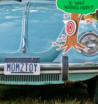 I Was Wrong About logo next to vanity license plate which reads "MOMZTOY".