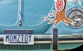 I Was Wrong About logo next to vanity license plate which reads "MOMZTOY".