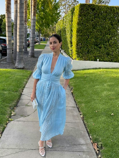 Rebecca Iloulian walking the street in a light blue dreamy romantic dress
