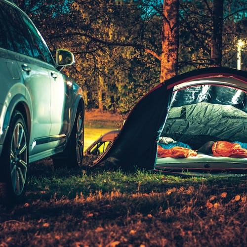 Tent set up at campsite with a sleeping pad for car camping