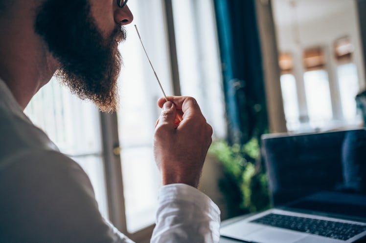 A man takes an at-home COVID test.