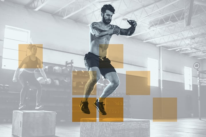 A man in black shorts jumping and doing cardio moves at the gym.