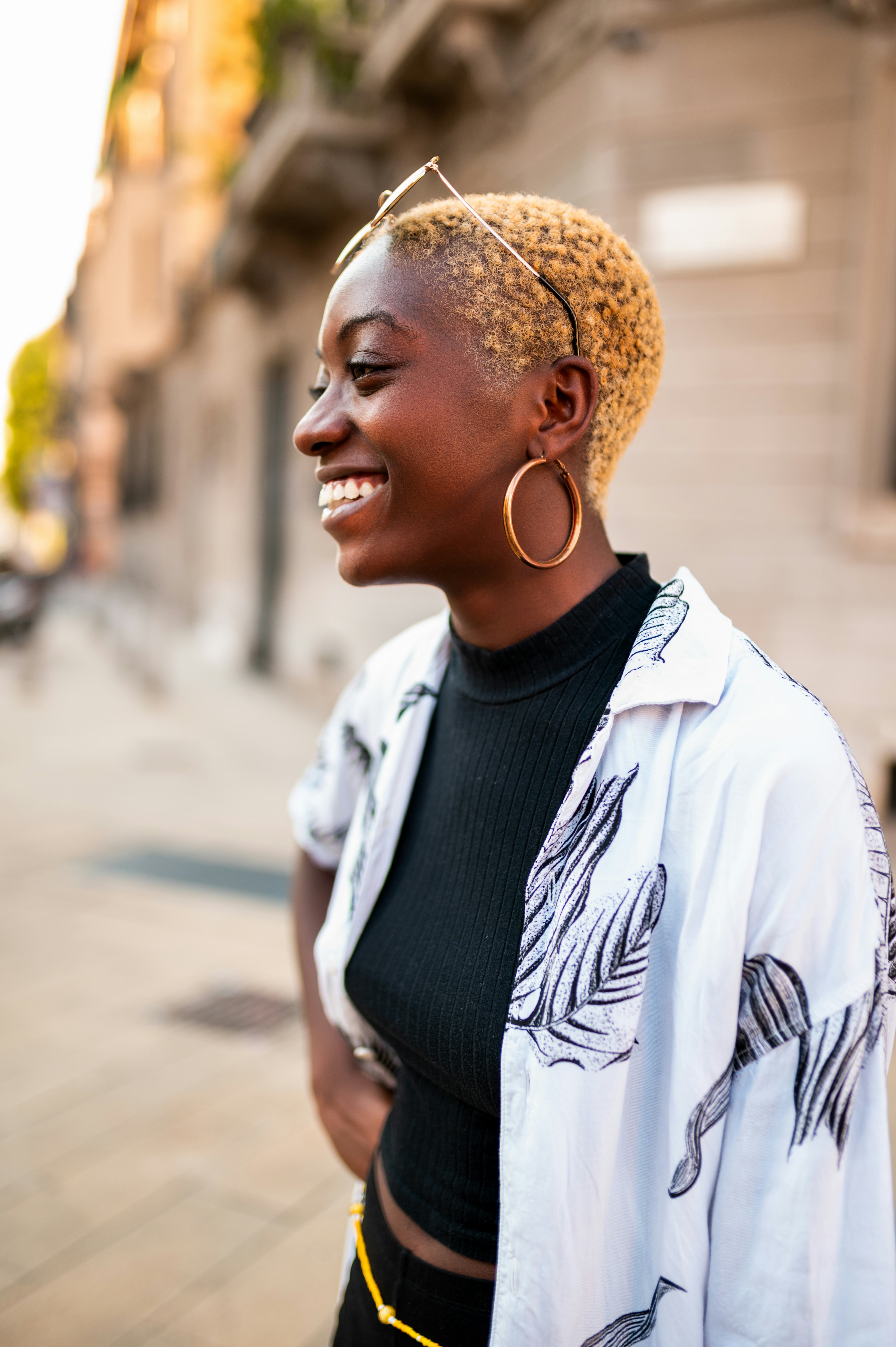 Young woman smiling during the July 2022 new moon in Leo, which will affect every zodiac sign's conf...