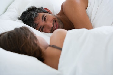A man and woman together in bed.