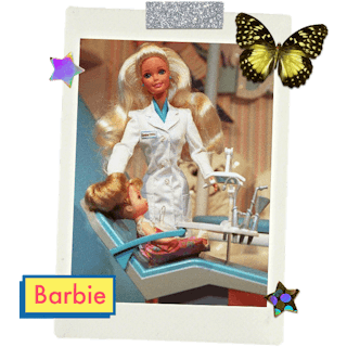 Barbie dressed as a dentist, with another little barbie doll sitting in the dentist chair.