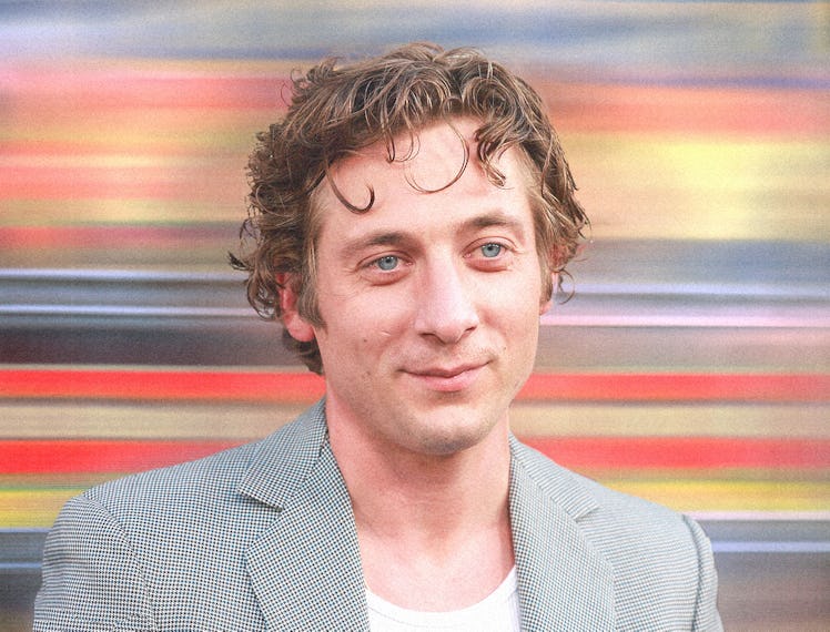 A portrait of Jeremy Allen White wearing a grey suit.