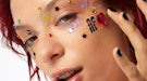 a model wears joystickers from af94, Halsey's new, affordable beauty brand.