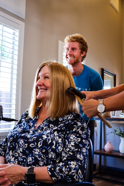 Matt Shaha watches as his mom gets the wig made from his hair styled for the first time.