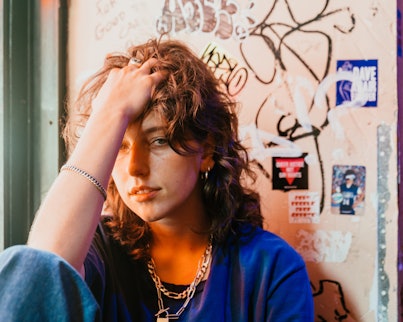 Musician Mikaela Straus known by her name King Princess with her hand in her hair