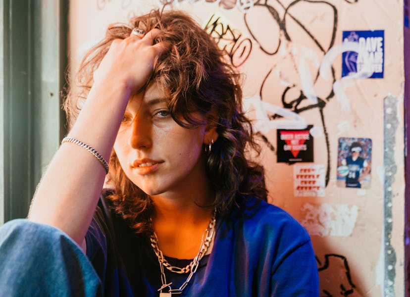 Musician Mikaela Straus known by her name King Princess with her hand in her hair