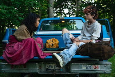 Taylor Russell and Timothée Chalamet sitting on a pickup truck in 'Bones and All'