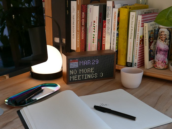 Tidbyt device on a desk showing date and calendar