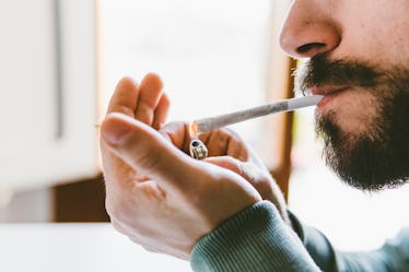 A man lighting up a joint.