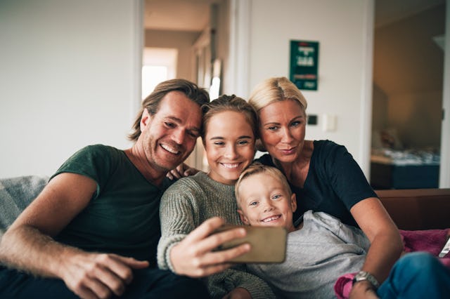 A family with a teen and a young boy pose for a photo.