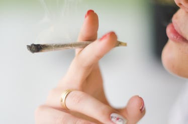 Close up of a woman smoking weed.