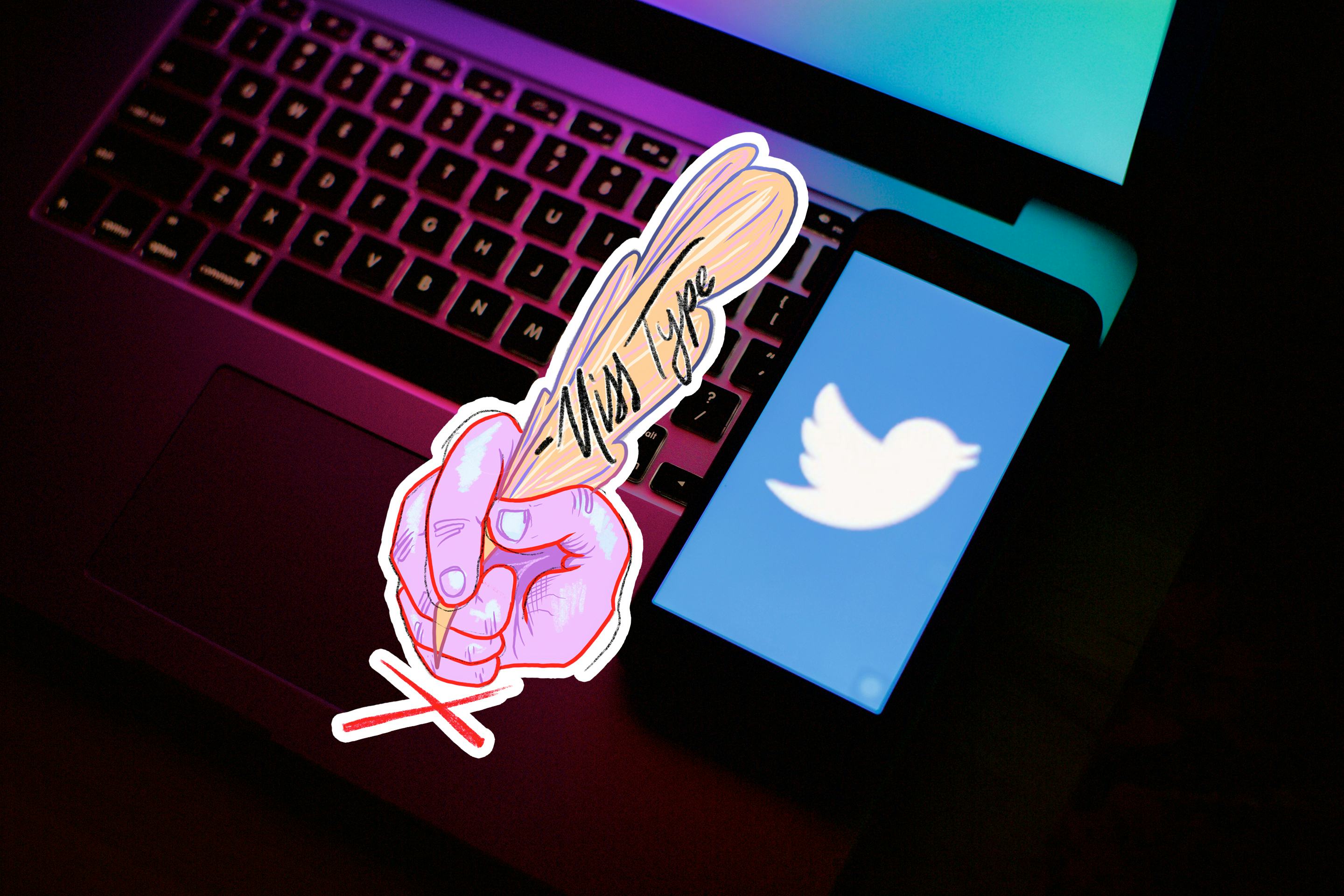 Twitter screen on a phone atop a laptop keyboard.