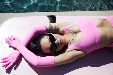 Bella Poarch in SKIMS' new, hot-pink bikini top and matching, opera gloves.
