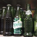 A lineup of vintage green Sprite bottles. Coca-Cola announced that the lemon lime soda will now come...