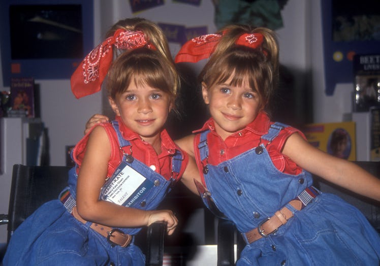 Mary-Kate and Ashley Olsen as children in overalls