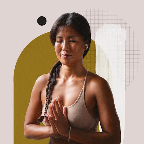 A brunette woman with her hands in a praying position during her meditation practice for coping with...