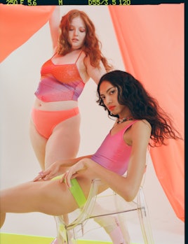 Two women wearing bright neon colored Urban Outfitters x Parade bras and underwear.